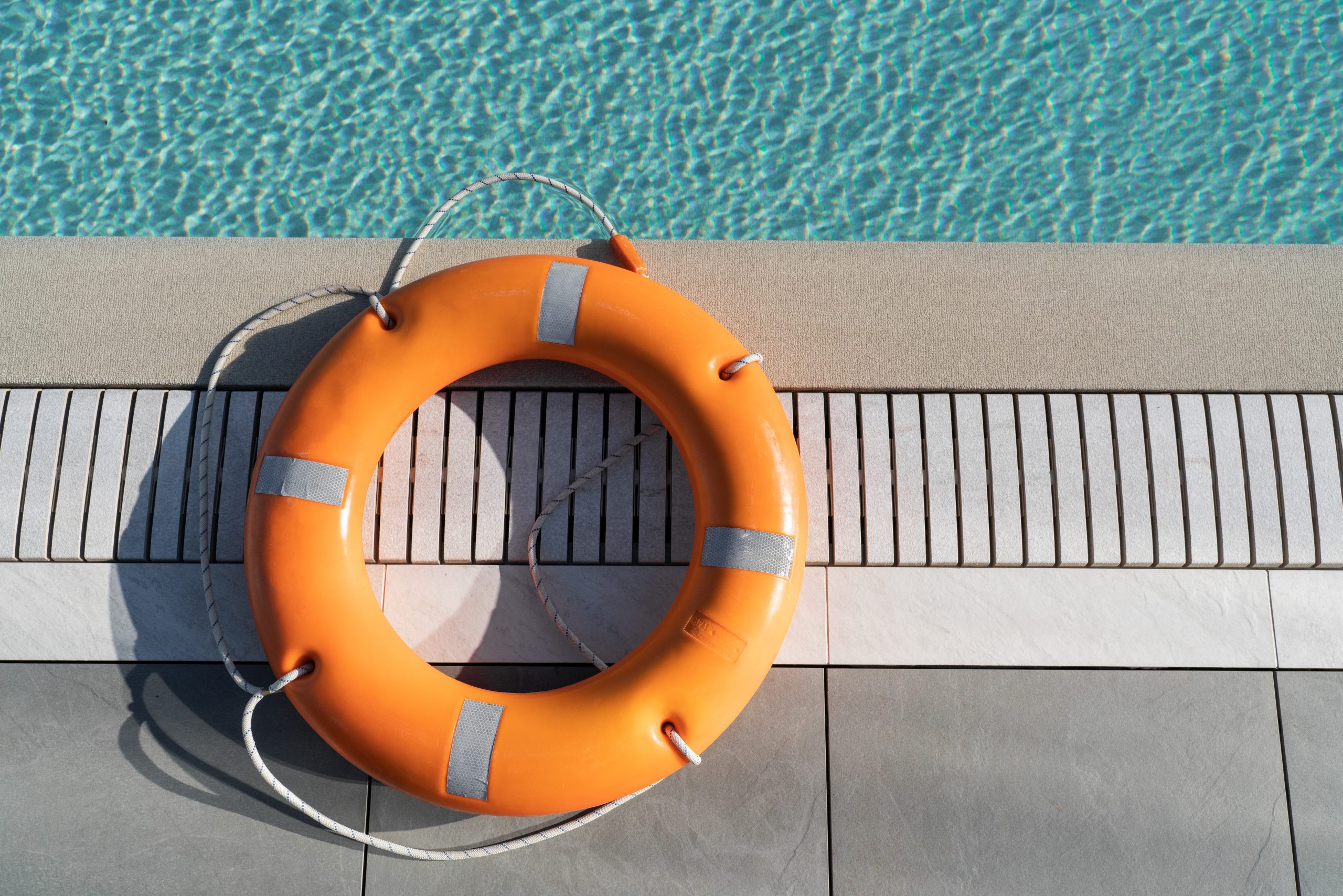 Orange lifebuoy by the pool